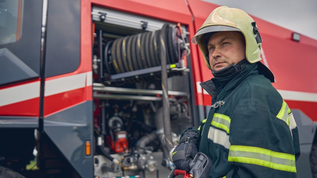 firefighter-is-standing-near-the-fire-truck (1)